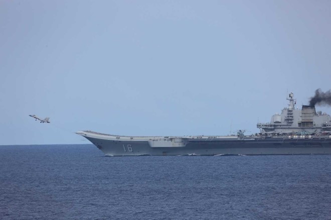 A J-15 carrier-based fighter aircraft is taking off from Chinese aircraft carrier Liaoning (Type 001).